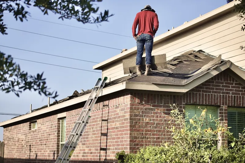 Professional roofer working on a residential roof in Bohemia